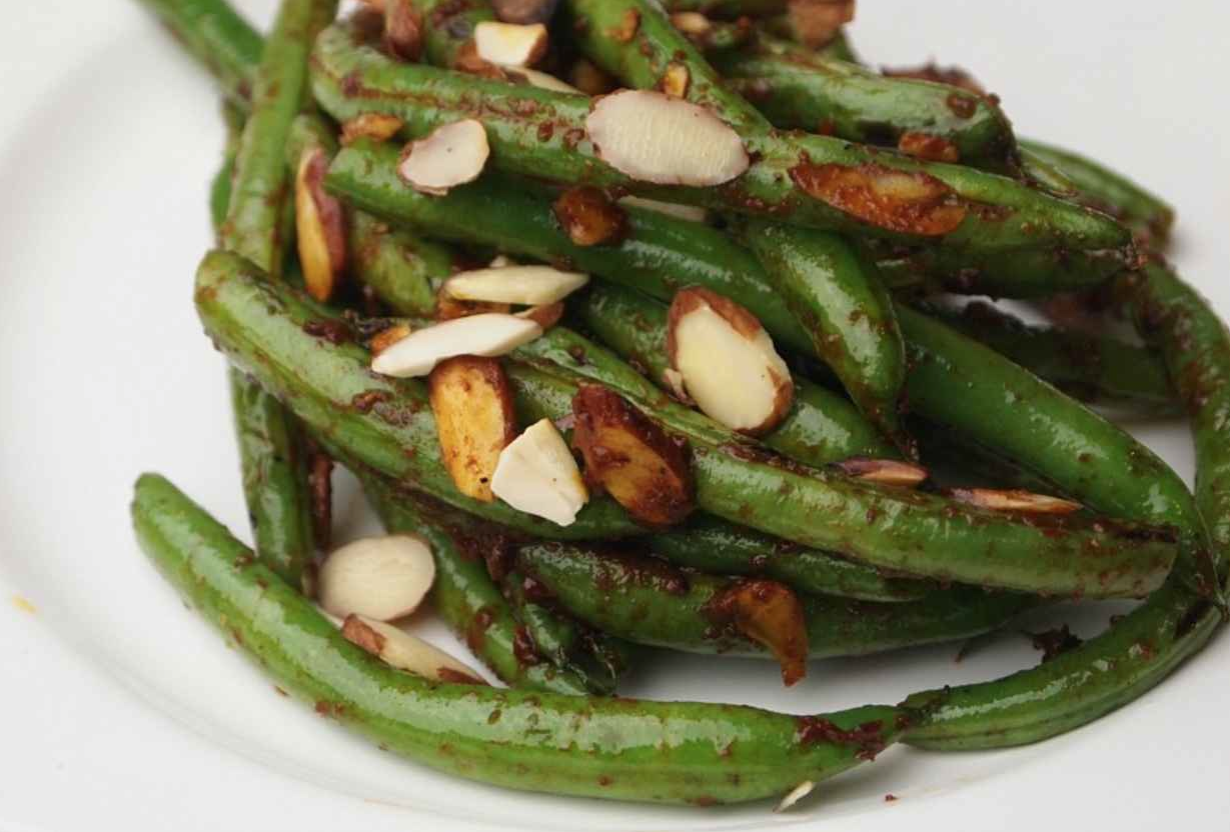 Joy of Kosher’s Pan Charred Green Beans with Harissa and Almonds by Tamar Genger